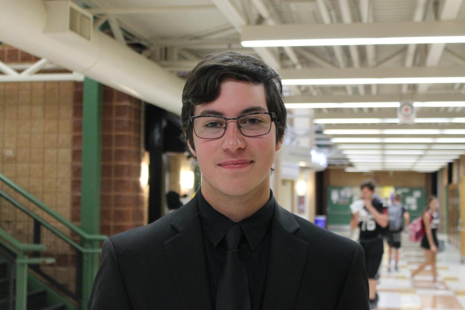 Dressed in his Jazz Band concert attire, senior Noah Korenfeld performs the trombone during lunch on the Friday of Homecoming.