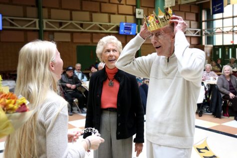 After being named king of the Turkey Dinner Dance, Bruce Hegger places his crown on his head. Hegger attended the event with his friend Vivian Powers, who was named queen.