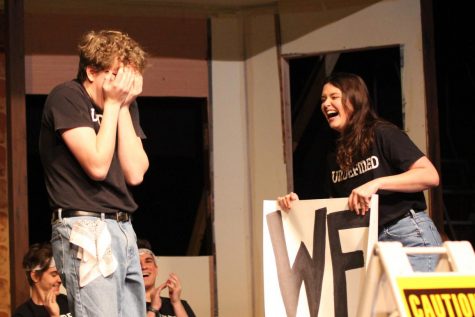 Holding a poster, senior Rachel Paese surprises senior Austin Laves by asking him to Winter Formal during the Undefined show during Flex on Jan. 22.