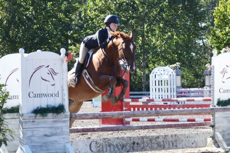 Sophomore Meredith Ambrose jumps her horse, Savia, over an obstacle during a competition at Camwood Farm in Tennessee.