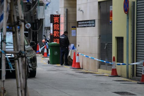 A security guard stands outside of a hotel in Macau, China that was converted into a quarantine area by the Chinese government. Photo labeled for reuse via Unsplash.