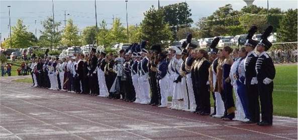 Drum Majors of participating bands await preliminary awards during a previous Contest.