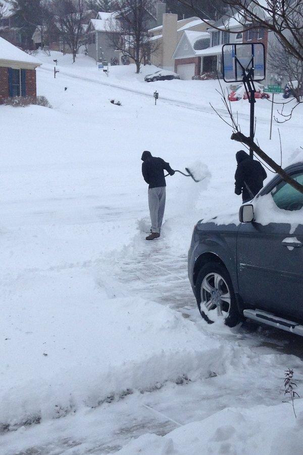 Sophomore David Marshall and his father shoveling snow to clear the driveway