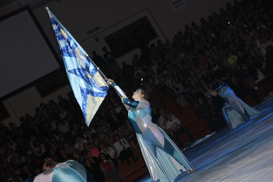 Senior Leah Gornet strikes a pose during the Winter Guard performance at the Academic Pep Assembly on March 11.