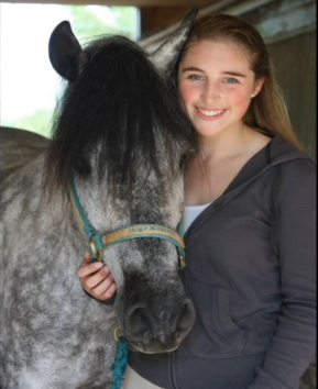 Senior Merill Morse and one of the many horses she spends time with