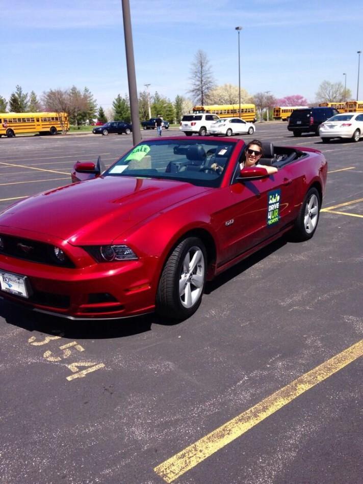 Senior Shelby Foley takes  a convertible red Mustang for a free test drive to support Lafayette Renaissance.