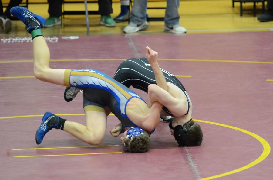 Varsity wrestling places third at Districts; qualifies nine for State