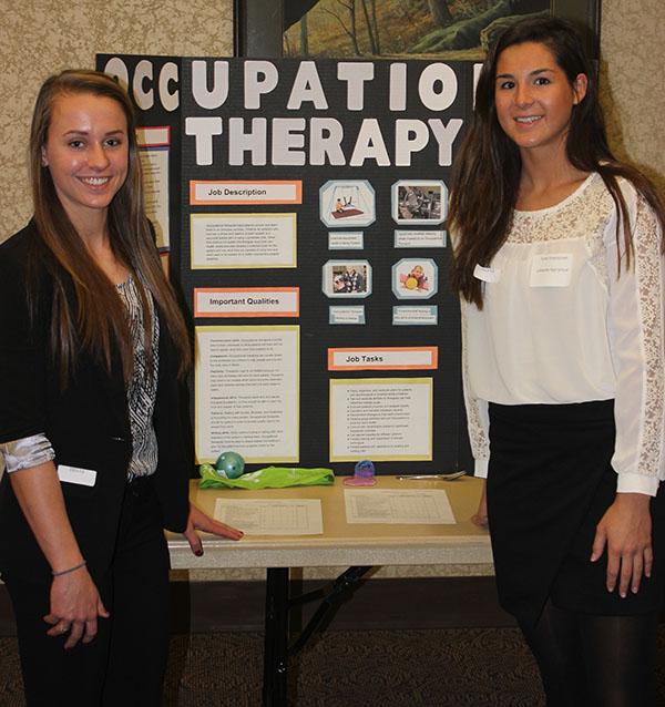 Juniors Jenny Kohl and Carly Emamjomeh stand by their poster for the State competition for HOSA. The duo got third place for their presentation over Occupational Therapy. and qualified for the National event in June. 