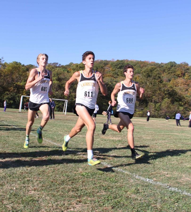 Austin Hindman, Devin Meyrer and Alec Haines race towards the finish line on the final stretch of the the Suburban West Conference meet
