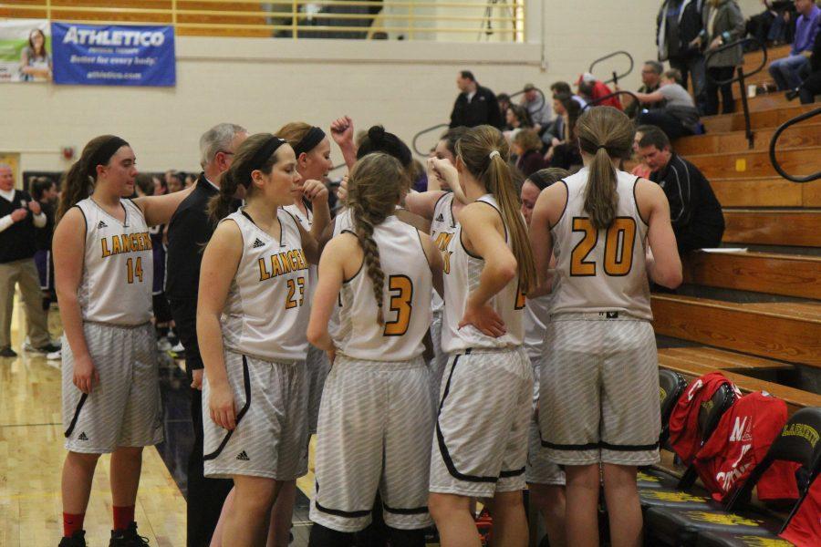 The girls basketball team huddles up in a game against Eureka.