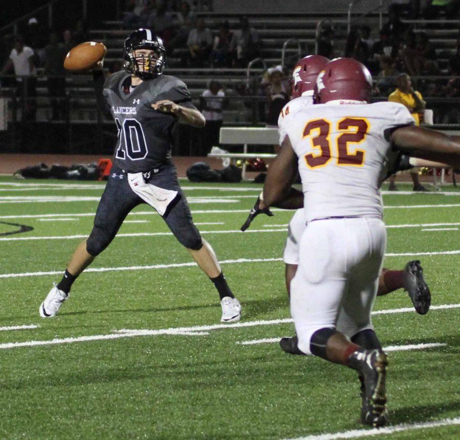 Lancer quarterback Ryan OConnell (10) drops back for the pass as he faces pressure from Hazelwood East defense. OConnell finished with 137 yards passing, three touchdowns and two interceptions in the winning effort over the Spartans.