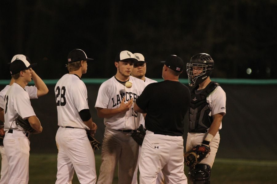 Head Coach Scott DeNoyer talks with Ryan OConnell (10) on the mound during a game against Marquette. The Lancers would go on to lose to the game 11-3.