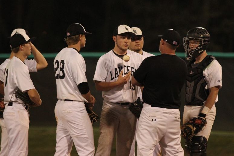 Head Coach Scott DeNoyer talks with Ryan O'Connell (10) on the mound during a game against Marquette. The Lancers would go on to lose to the game 11-3.
