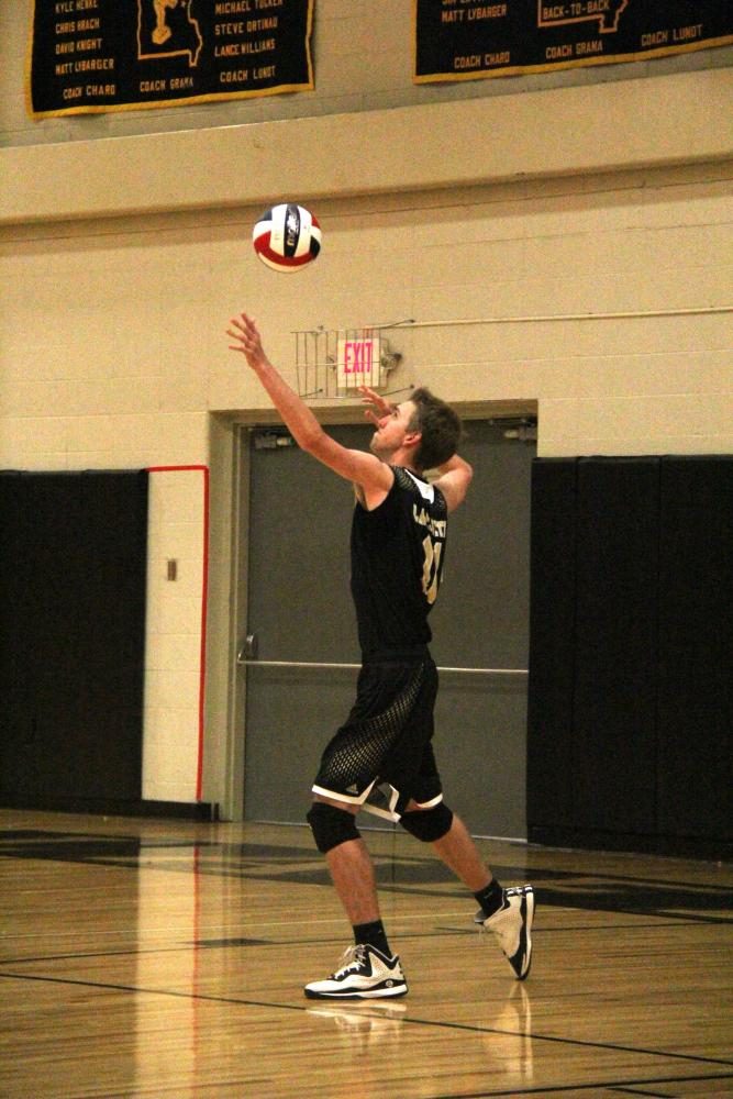 Facing off against Seckman, Reed Parris, junior, serves the ball to the opponent’s court. “All levels of volleyball are tightly knit, they all know each other so it’s fun to be around them at practices and games,” Parris said.
