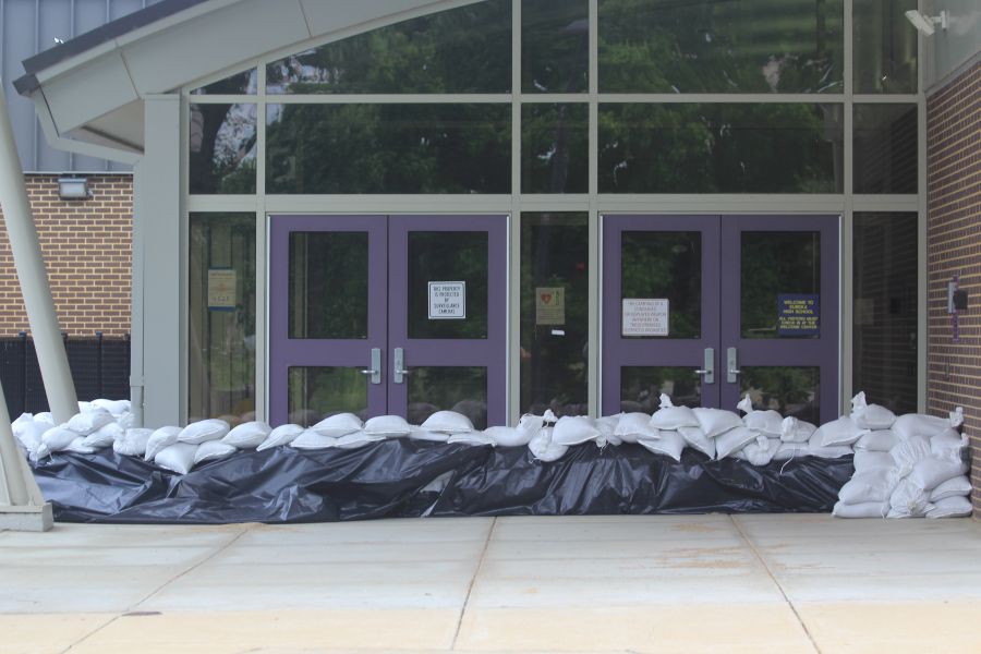 Sand bags surround an entrance at Eureka High School after volunteers spend hours the day before filling sand bags.