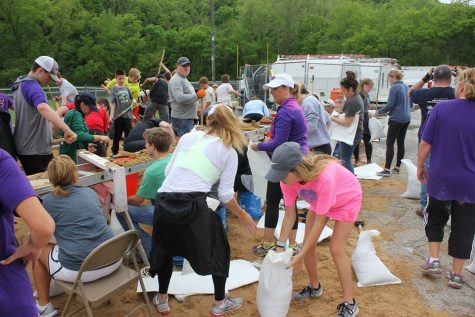 Volunteers fill sandbags at Eureka High School in an attempt to keep water away from the school.