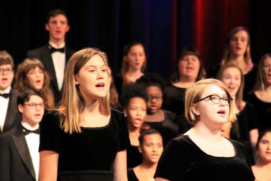 Junior Hannah Wozniak and sophomore Sarah Collins perform in the  2016 Winter Choir Concert.