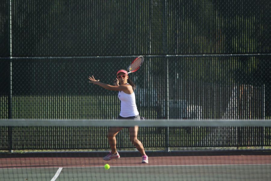 In an attempt to win the point, senior Nina Ruan swings back her racket. Ruan is apart of the varsity squad traveling to Springfield, MO to compete in the State tournament. 