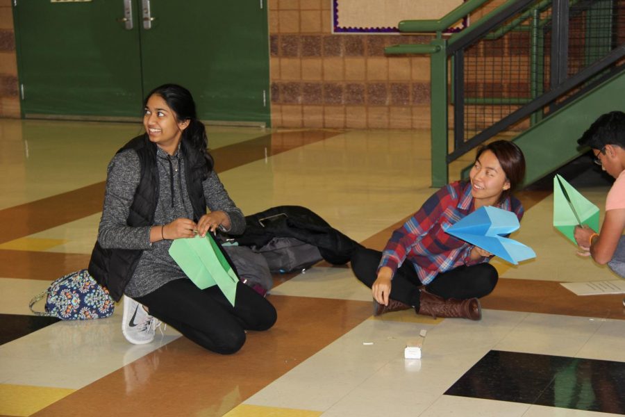 Juniors Sydney Kim and Shreya Chengalvala construct paper airplanes while participating in STEM Night.