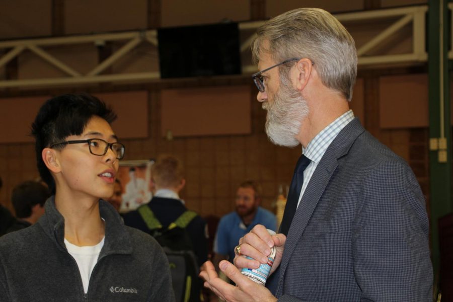 Senior Jojo Lu, organizer of STEM Night, talks with Superintendent Eric Knost during the event.