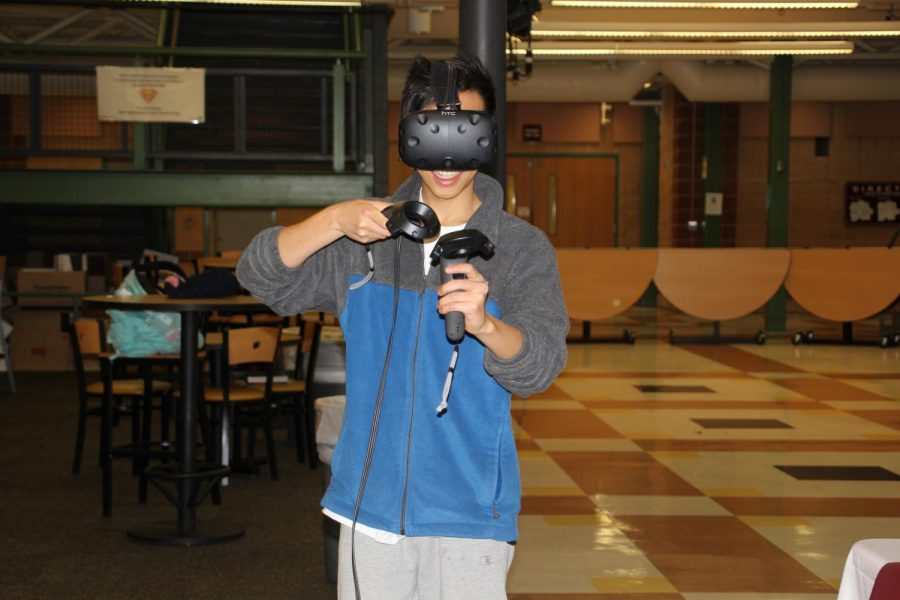 Senior Jojo Lu, organizer of STEM Night, tests a virtual reality simulator.