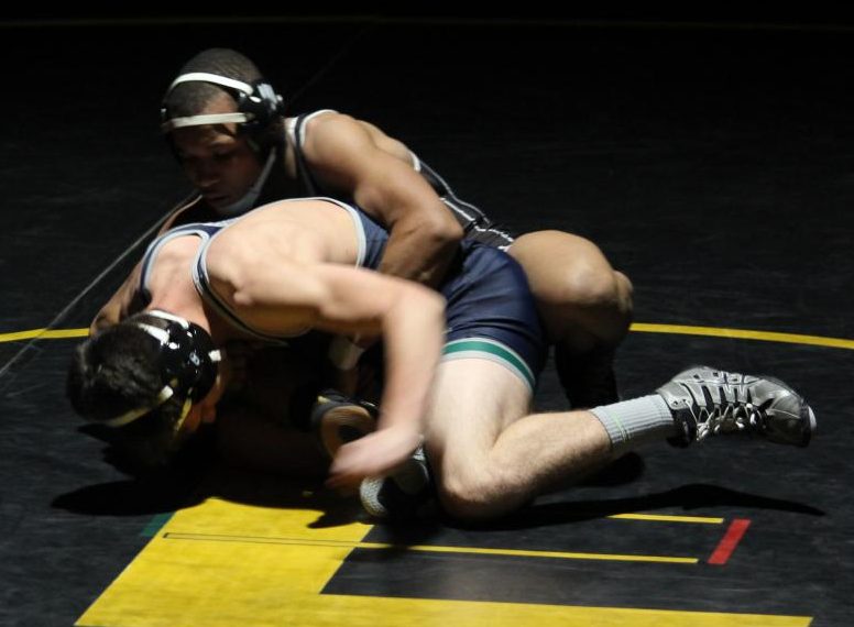Attempting to pin his opponent, junior Jaylen Carson tries to win his match against Timberland on Wednesday, November 29. Last year, Carson finished third in his weight class at State.