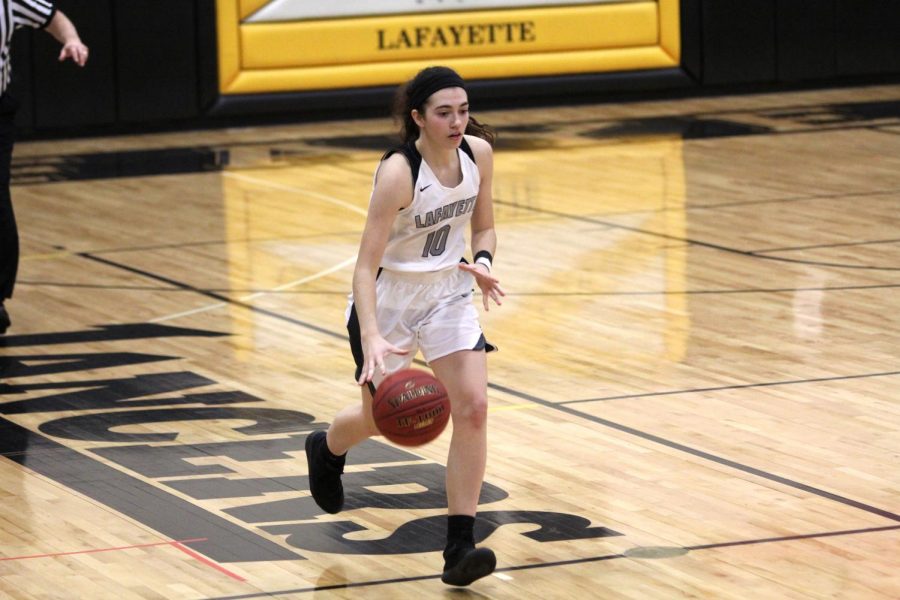Senior Lydia Harris pushes the ball up the court in a game against Parkway South. The Lady Lancers defeated the Patriots 39-34. 