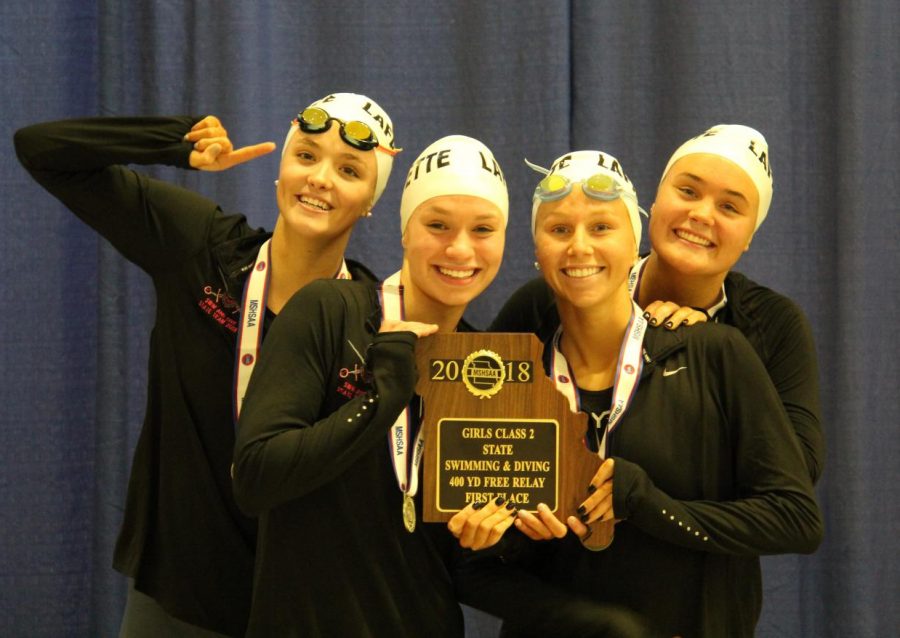 Senior Delaney Thomas, senior Franceska Petrosino, junior Cate Behl and sophomore Claire VanBiljon celebrate after winning the 400-yard 
freestyle relay at the State Championship meet. The Lady Lancers placed second overall at the meet. 