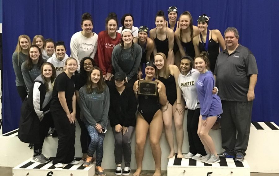 The+girls+swim+poses+with+their+first+place+trophy+at+the+Springfield+Invitational+Meet+in+Springfield%2C+MO.+