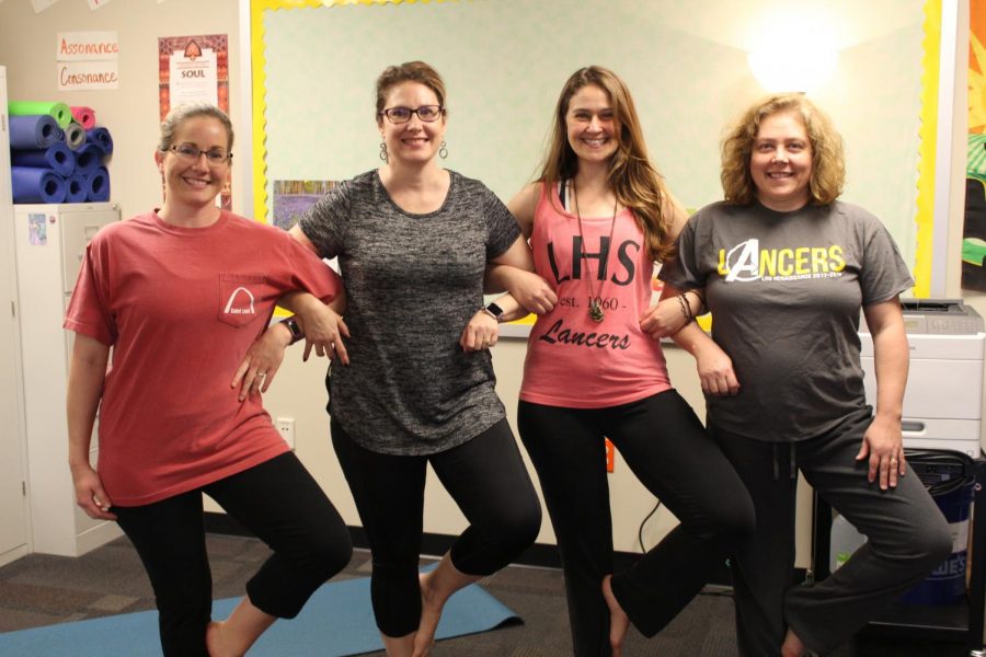 Yoga+for+teachers+stretch+together+before+they+start+their+yoga+routine.+