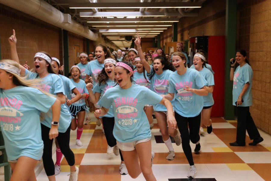 Before school on Thursday, Sept. 27, Lilly Shaikun dashes through the halls with the junior girls as they cheer themselves on, making several laps around the school. The juniors lost to the seniors that night in the annual Powderpuff game. My favorite part of Powderpuff was getting to come together as one big junior family and having the experience with other people outside of my friend group, Shaikun said.