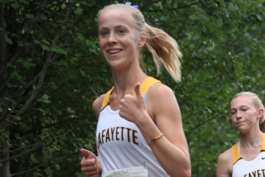 Running in the Parkway West Invitational at Living Word Church, senior Anna Karner expresses her enthusiasm. Karner finished sixth in the race on Sept. 29, and this weekend, on Nov. 3, she will race in the State Championship Meet. 