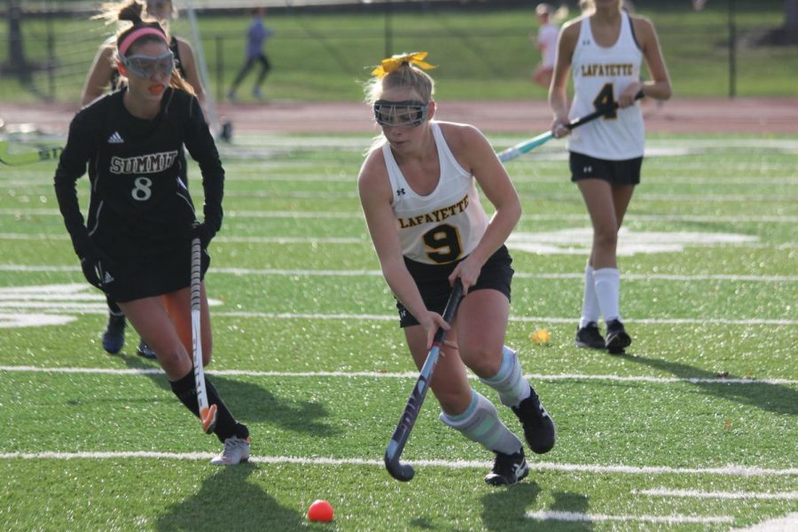 During the Oct. 15 field hockey game against Rockwood Summit, senior Lilly Balderson pushes the ball down the field. The Lady Lancers fell to the Falcons 1-2, but they ended the regular season with a 12-8 record. The Lady Lancers next game is on Oct. 30 against MICDS where the girls will attempt to advance to the Final Four of the State Tournament.