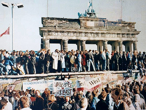 Citizens of East and West Berlin celebrate the fall of The Berlin Wall.