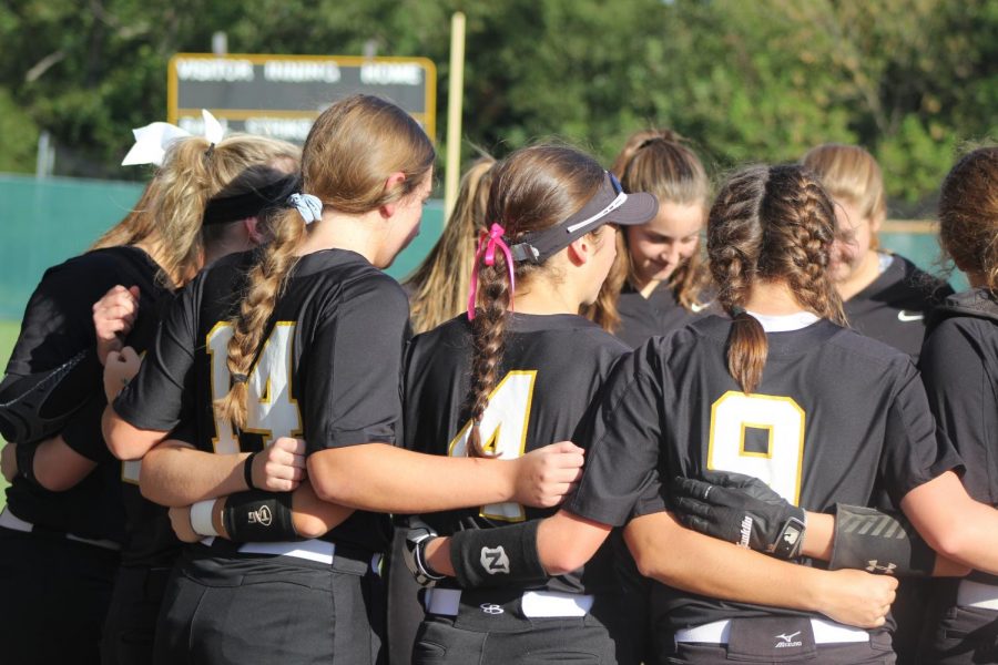 Before a home softball game against Francis Howell North on Oct. 1, the softball team huddles together. The team won 6-0. 