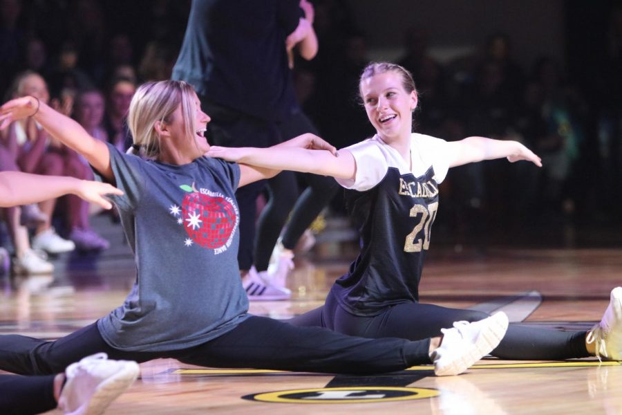 Exchanging a smile, junior Leenie Johns and Escadrille Coach April Ehrhardt end the Escadrille teacher dance in the splits.