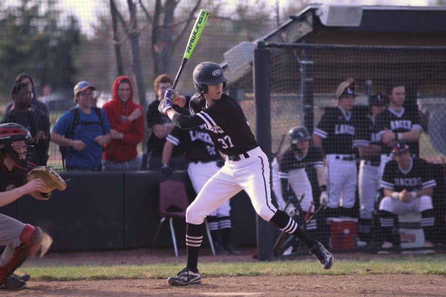 Junior Zach Bryce loads his bat to hit the ball. Bryce currently has a .500 batting average along with three hits.