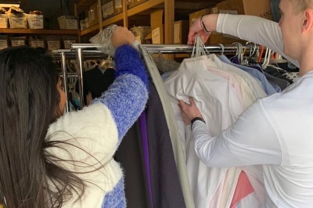 Senior Kashish Gupta (left) and junior Geoff Ladue sort through donated clothing items. This year, FBLA hosted their second annual business wear drive and increased their collections from last year.