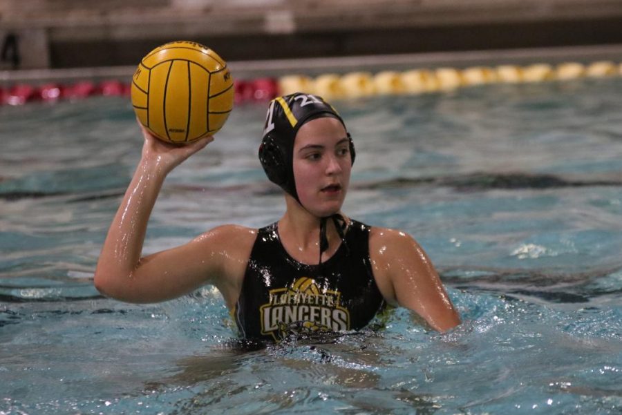 During the March 26 girls water polo game, sophomore Sophie Arceneaux looks to pass to a teammate down the pool.  