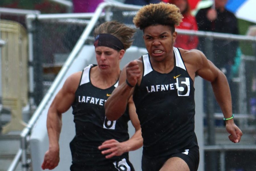 In the District Meet at Eureka on May 11, junior Marsean Fisher sprints towards the finish line with determination in the 100-meter dash. Fisher claimed the District Championship title in the race after finishing in 11.67. 