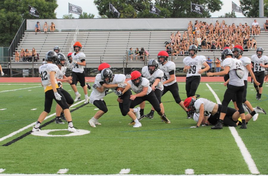 At the community event on Aug. 24, Lafayette junior varsity football scrimmaged against themselves, using red caps to represent defense.