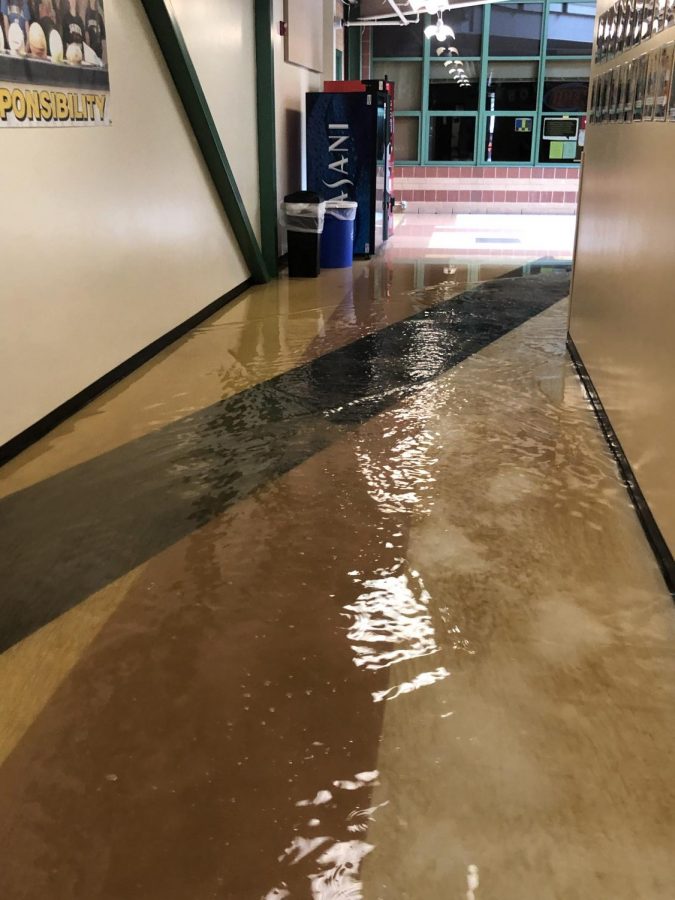 Standing water fills the hallway outside Room 183 before CATCO crews arrive, Aug. 17.