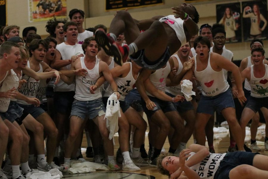 During the male escadrille performance, senior Jalin Reese does a back tuck over Josh Hansen.  His back tuck was one of two flips that was showcased in the dance.