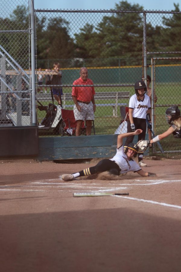 Another Lancer crosses home plate in a close play. The Lancers went on to win the game against the Lindbergh Flyers 12- 7. 