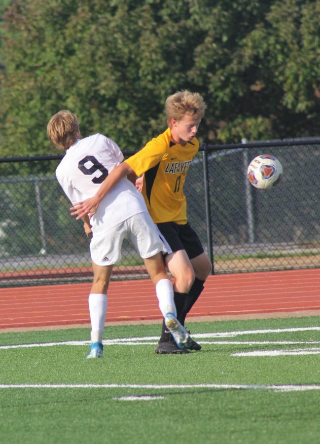Senior Kyle Klostermann moves around a Lindbergh defender in order to gain the balls possession.