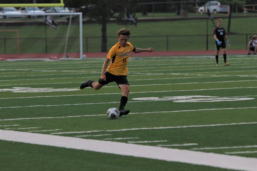 Junior Ben MacInnes prepares to kick the ball up the field in a game against Marquette on Sept. 10. The Lancers fell to the Mustangs, 3-1, but play them again in the first game of Districts on Nov. 4 at Lafayette.