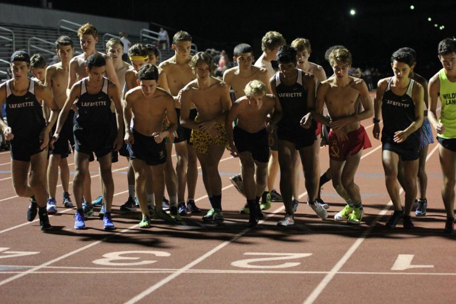 The boys cross country team prepares to start their first timed run of the season in the time trials.