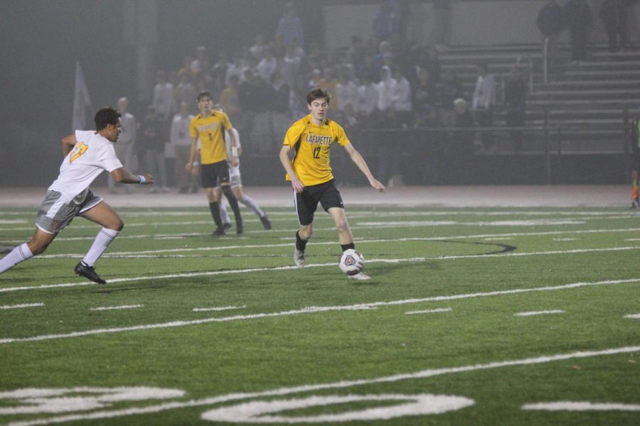 In the District Final, junior Mitchell Grant outruns a CBC defender. The Lancers lost the game, 1-0 in overtime, and ended the season with a record of 18-7-1.