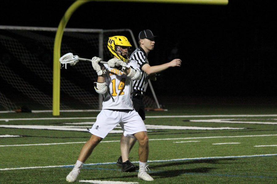 At+the+game+against+Marquette%2C+Senior+Braeden+Williams+prepares+to+throw+the+ball+downfield.+