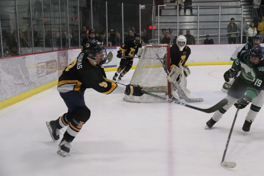In the quarterfinal game against Marquette, defenseman Jack Thomas shoots the puck out of his teams area. On Feb. 22, Thomas scored the game-winning goal against Vianney. The Lancers will play Vianney again on Feb. 29.